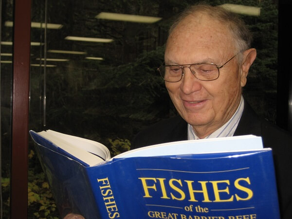 gil bane reading a book about fishes