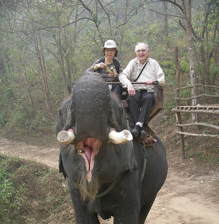 gil and janet bane riding an elephant