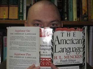 Jared holding a book "The American Language" by H. L. Mencken