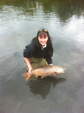 Lorraine Stewart in the water holding a salmon