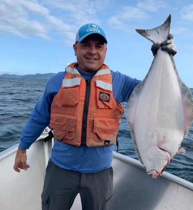 Rich Gonzalez holding a halibut