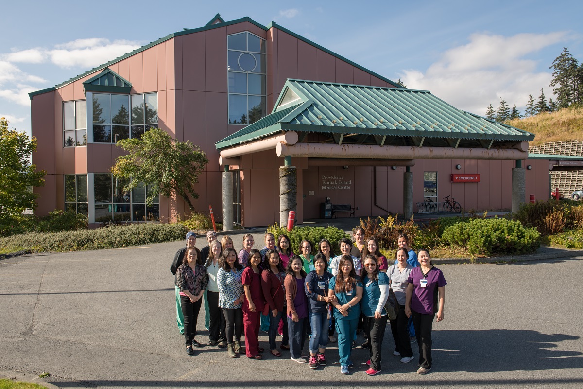 group of medical professionals posing standing outside the emergency entrance of Providence Kodiak Island Medical Center