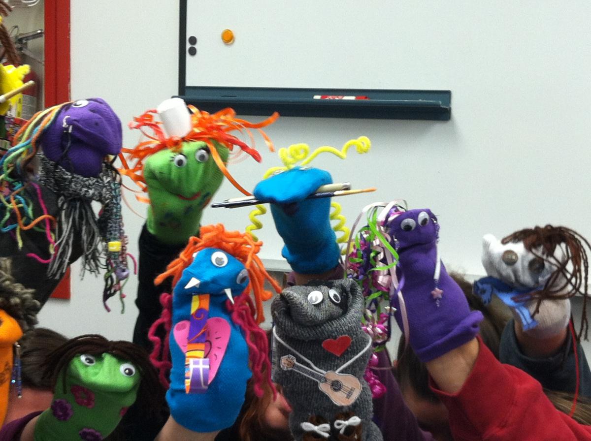 a group of homemade sock puppets on people's arms
