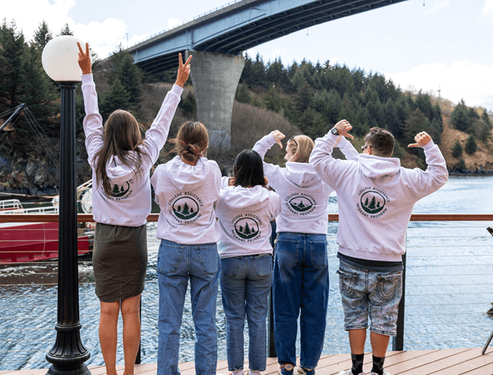 students wearing CAMP sweatshirts looking over Near Island Channel