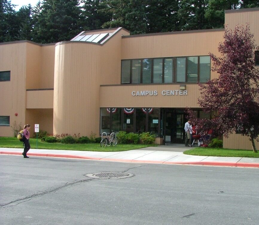 Kodiak College campus center with people grilling