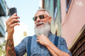 man with a beard holding a cellphone