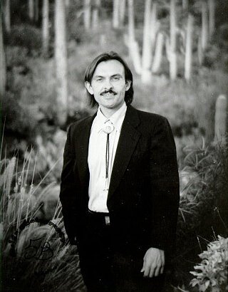 Lewis Mehl-Madrona standing in the desert
