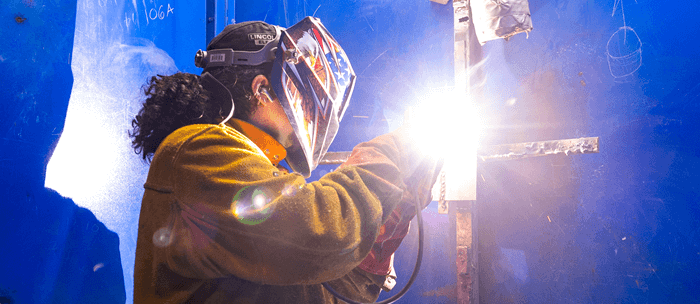 student welding 