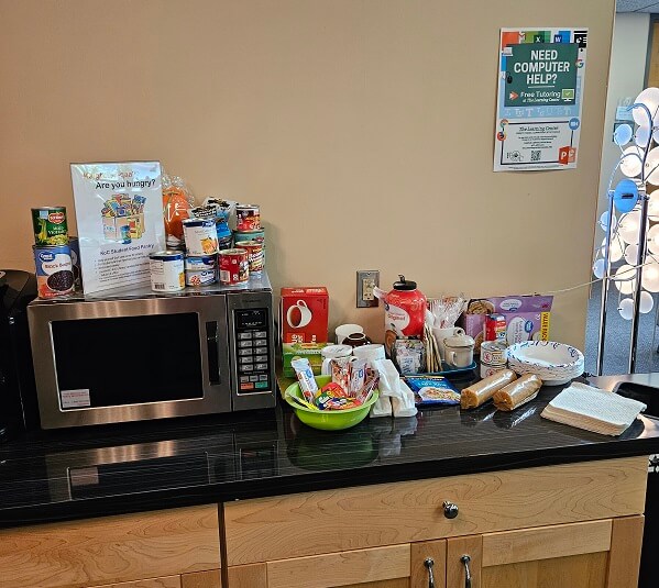 small food pantry with non-perishable items and a microwave