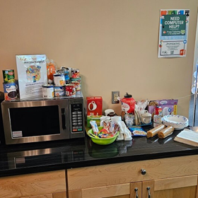 food pantry items on a table with a microwave