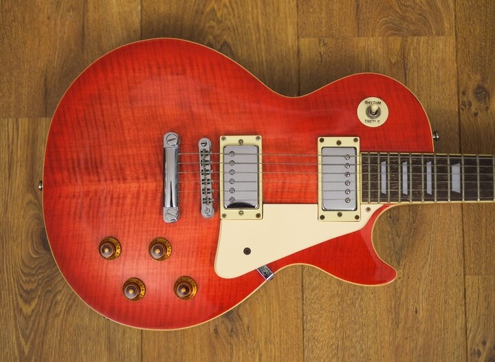 a red and white Gibson Les Paul guitar