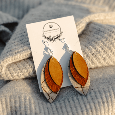 a pair of oval leather earrings