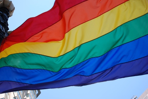 a pride rainbow flag flapping in the wind