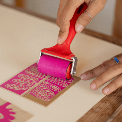 person rolling ink onto a print surface