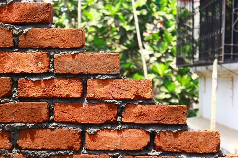 bricks being laid into a wall