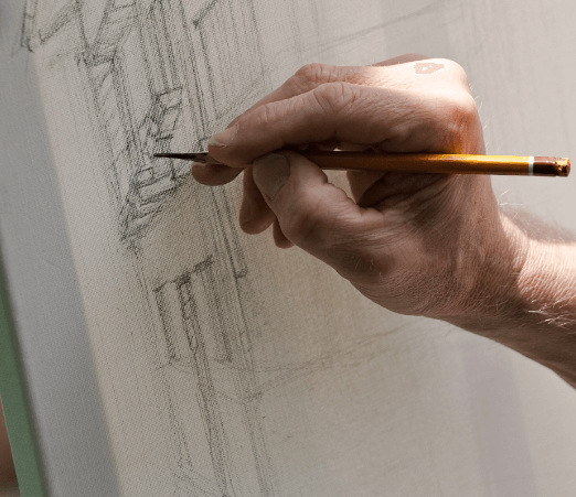 A hand sketching with a pencil