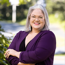 Jacelyn Keys standing outside in a purple blazer