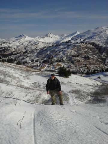 Kat Gambling standing in a snowy mountain valley