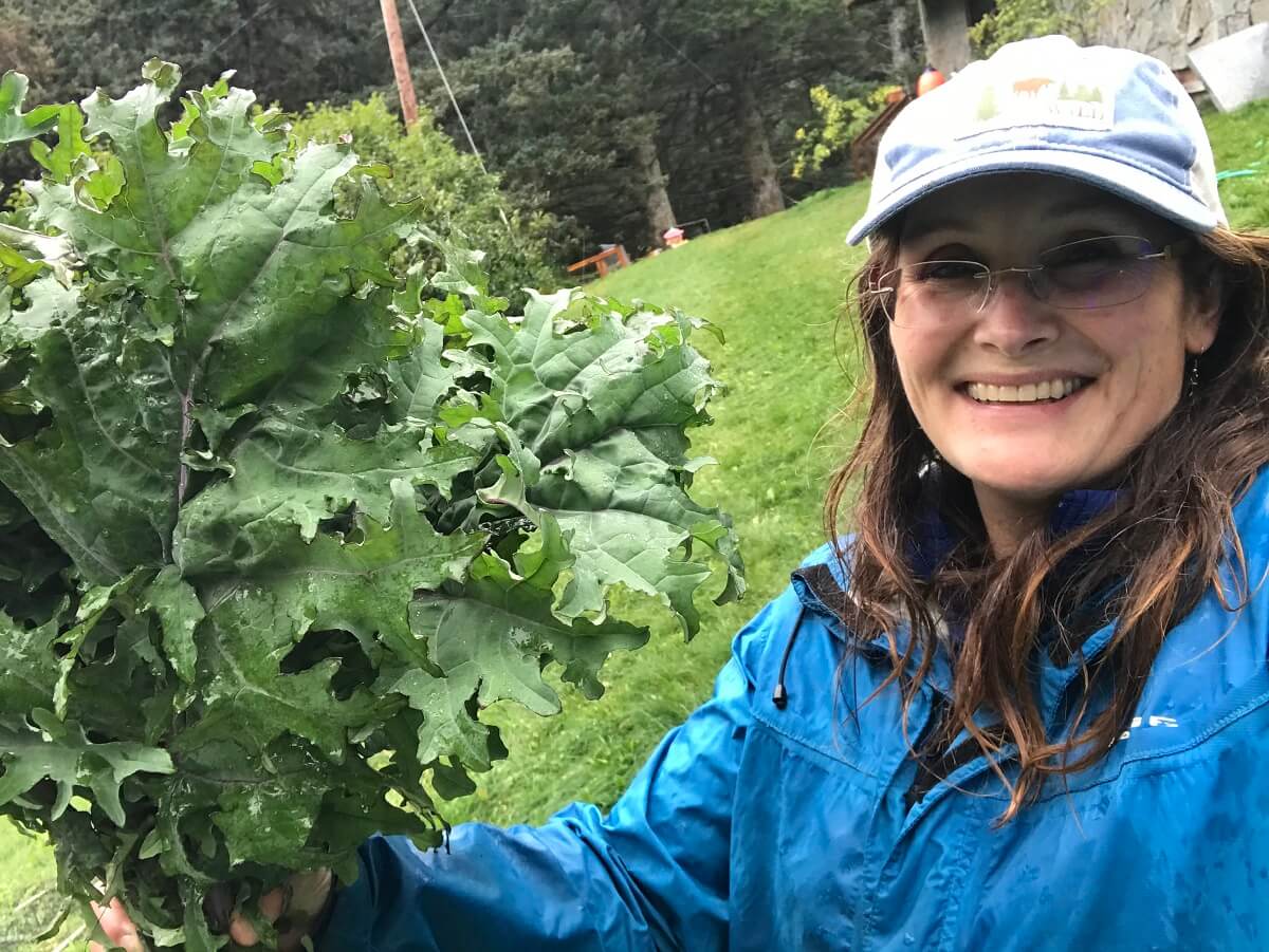 woman holding a bunch of Kale