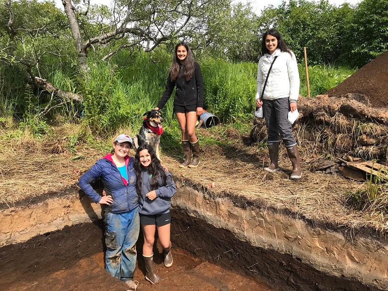 a mother and 3 daughters at an archaeological dig