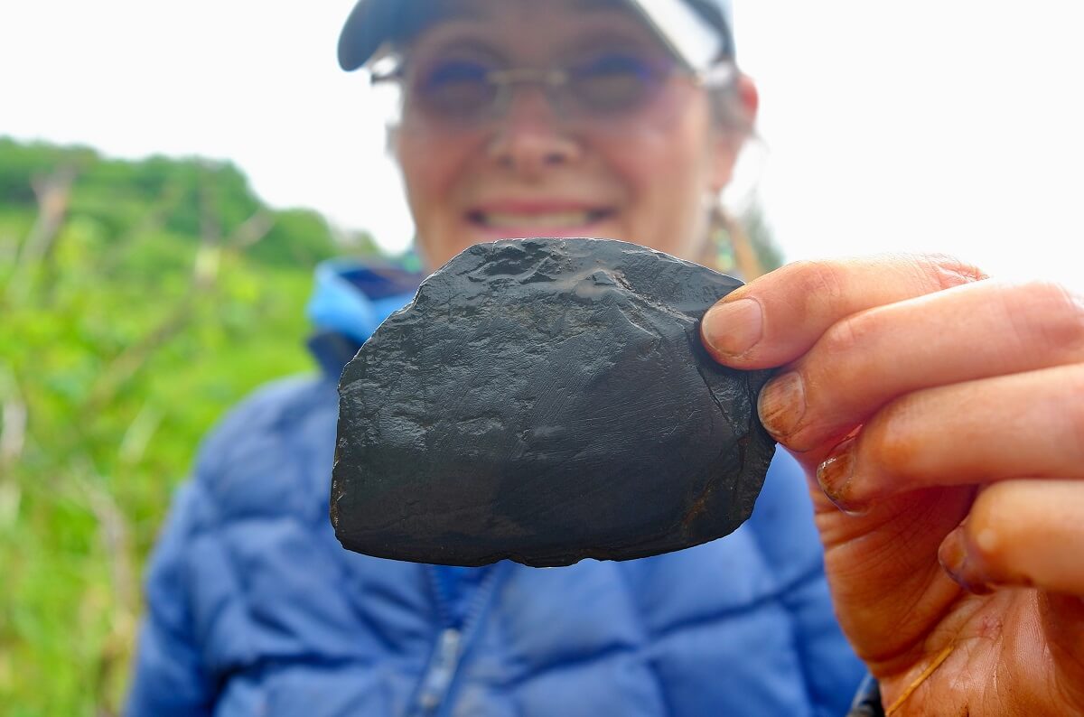 woman holding a stone ulu