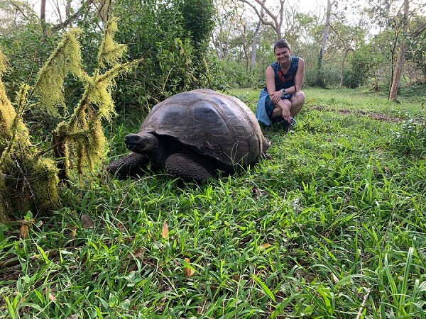 meghan kelly standing behind a tortoise