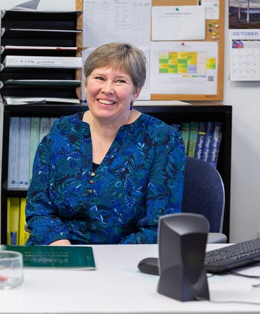 Questa harper at a desk