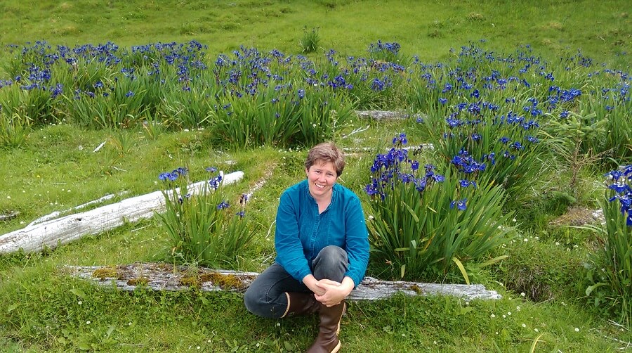 Questa Harper sitting in a grassy meadow