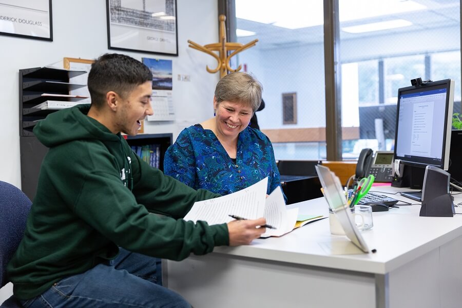 Questa Harper helping a student at a desk