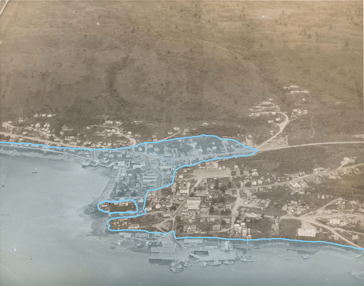 an aerial photograph of the town of Kodiak with superimposed blue shading showing the inundation line of the 1964 tsunami 