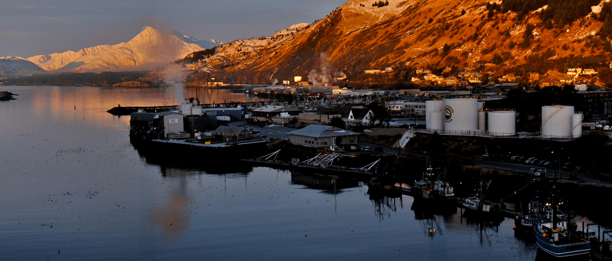 Color photograph of current day Kodiak harbor with pillar mountain in the background