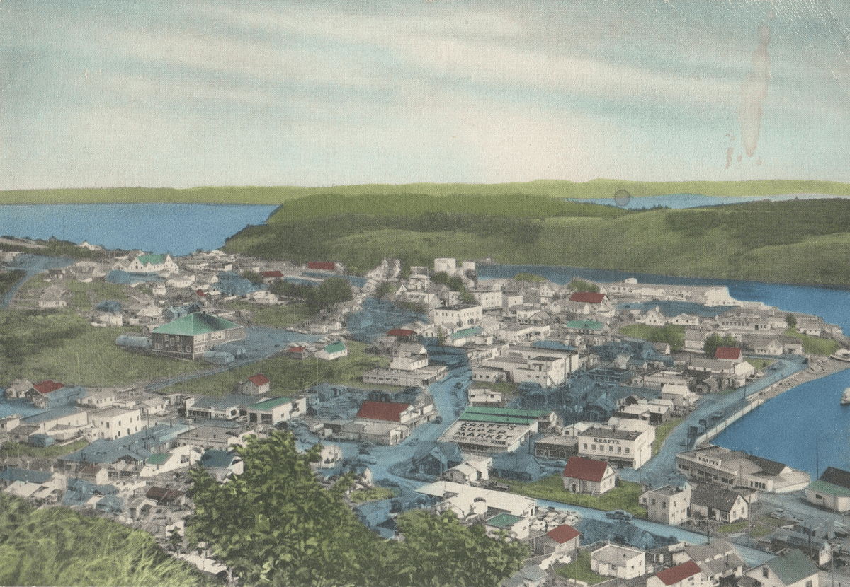 colorized black and white photograph of downtown kodiak and harbor before the tsunami