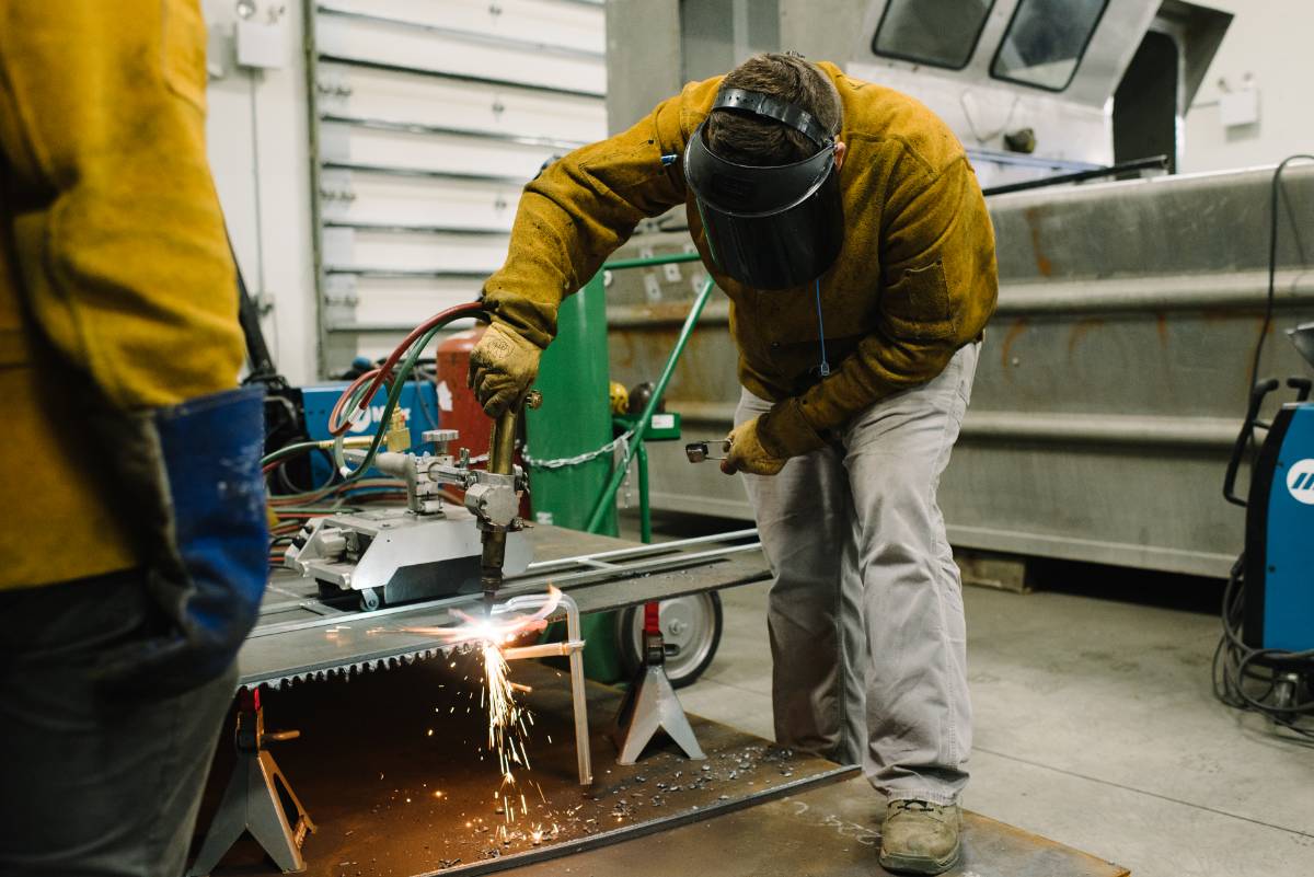 student welding at a table